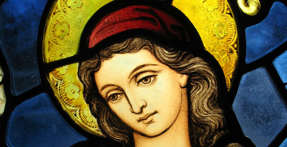 Photo of stained glass window detail of Virgin Mary inside Saint John's church in Washington D.C. This church is near the White House and has been used for worship by many presidents of the United States.
